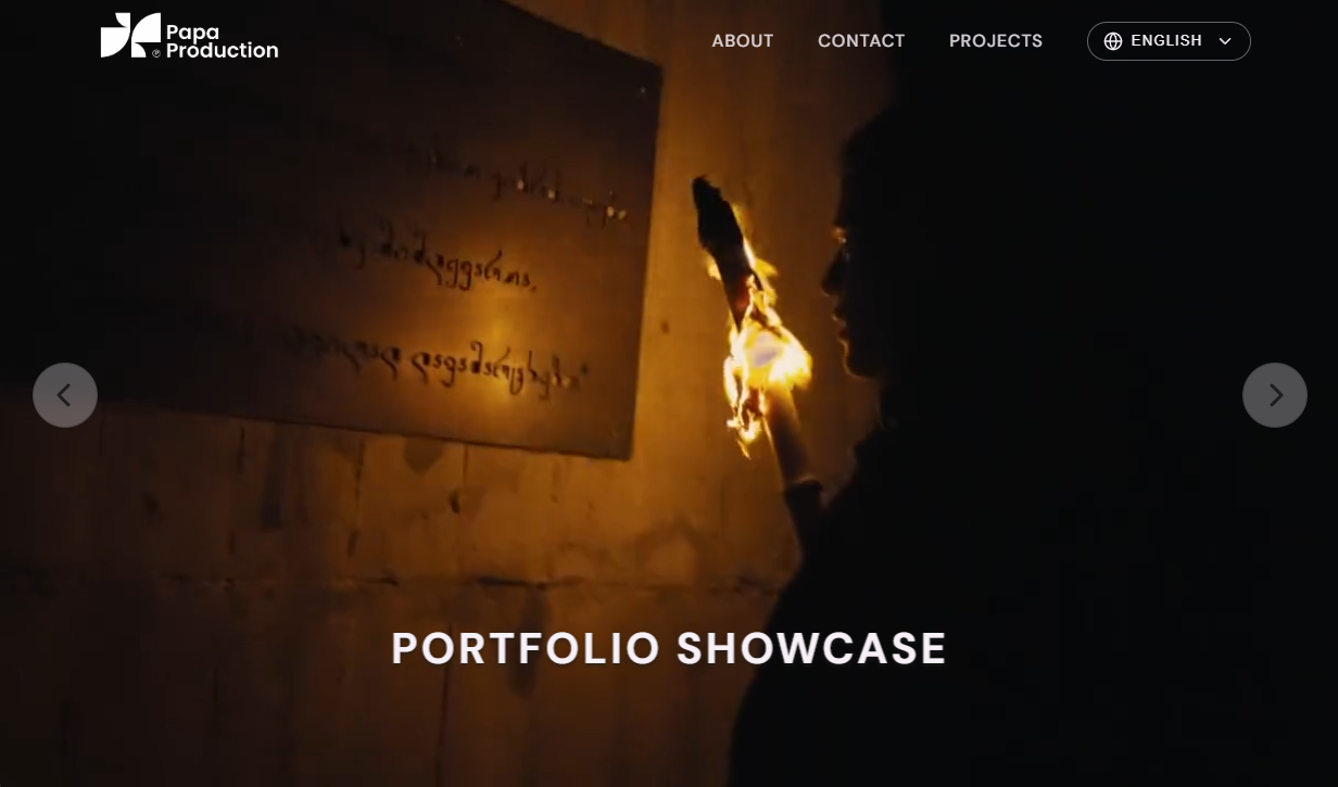 Desktop portfolio showcase page with cinematic video imagery, navigation, and carousel controls